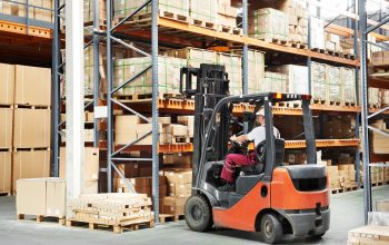 worker driver at warehouse forklift loader works
